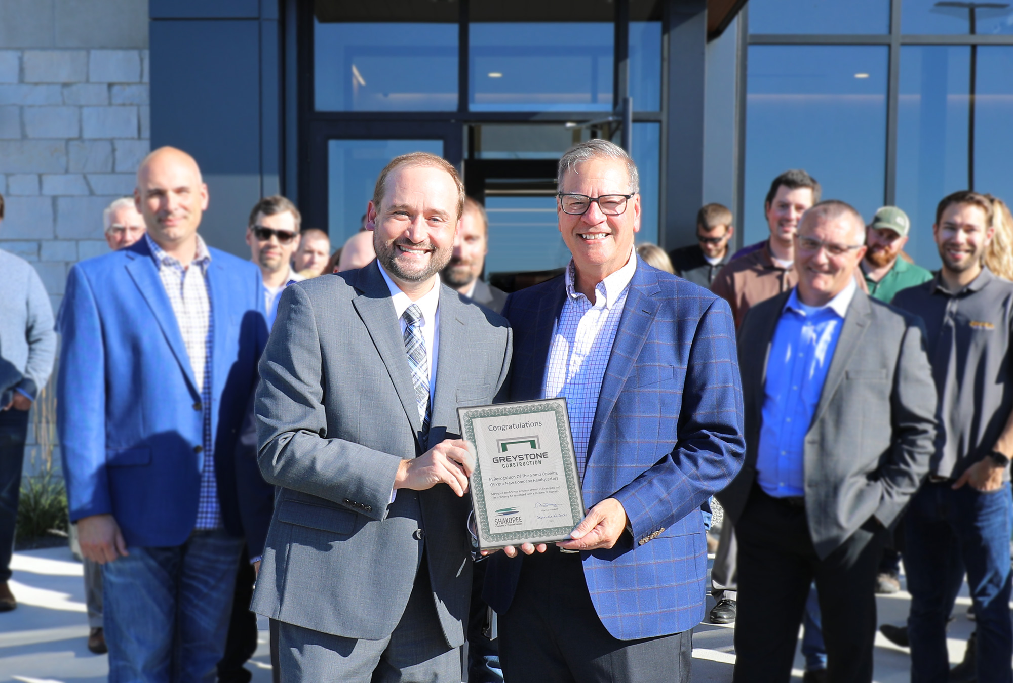 Shakopee Chamber President Tim Zunker presents Greystone Construction CEO Kevin O'Brien with plaque